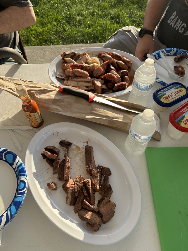 Plates on a table filled with grilled items.