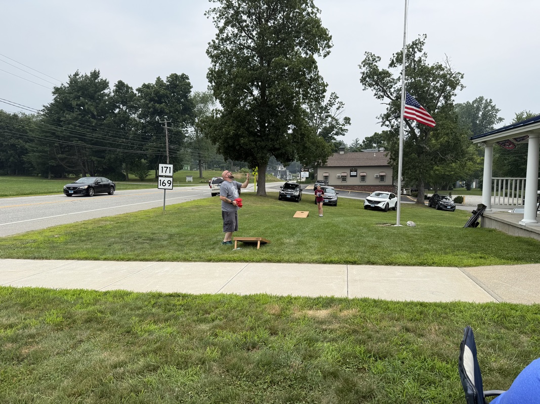 Brother Justin Kupiec playing lawn games with his daughter