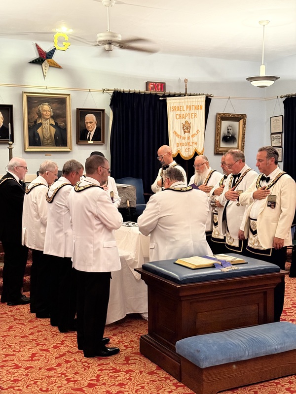 Grand lodge officers in white jackets presenting the rededication ceremony