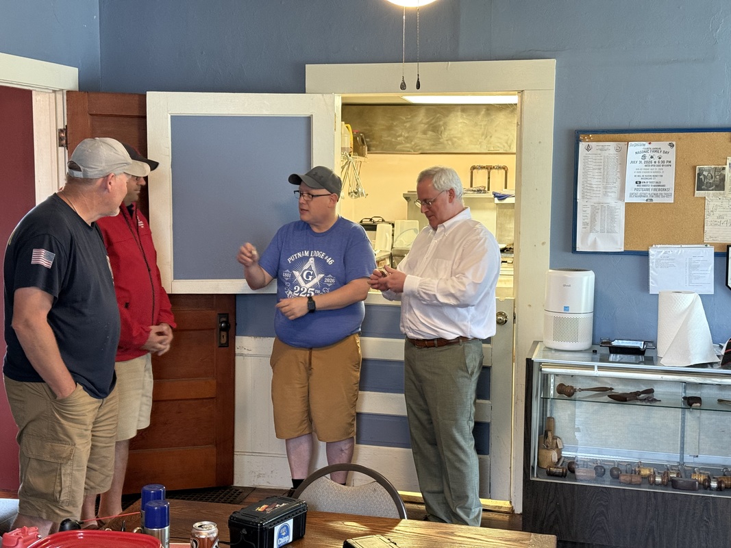 WM John S. Rhoads presenting challenge coins to Representative Pat Boyd and Senator Jeff Gordon