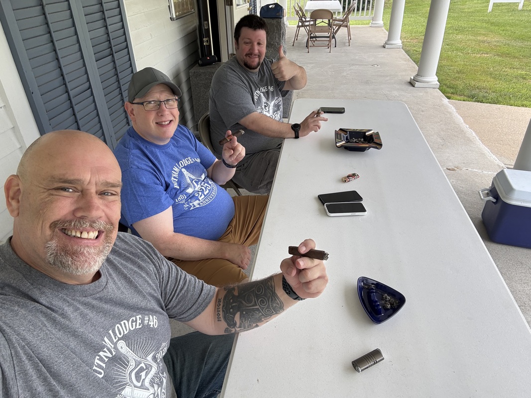 Brothers Craig Chatwin and Robert Dean III enjoying cigars with WM John S. Rhoads.