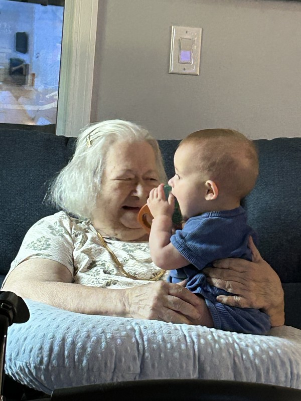 Grandma and great grandson together on couch.