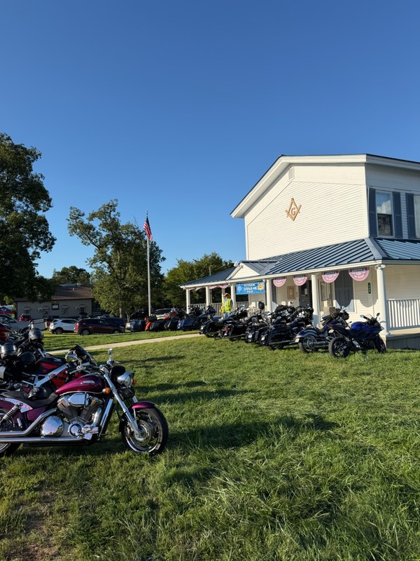 A veiw of the lodge with motorcycles parked in front.