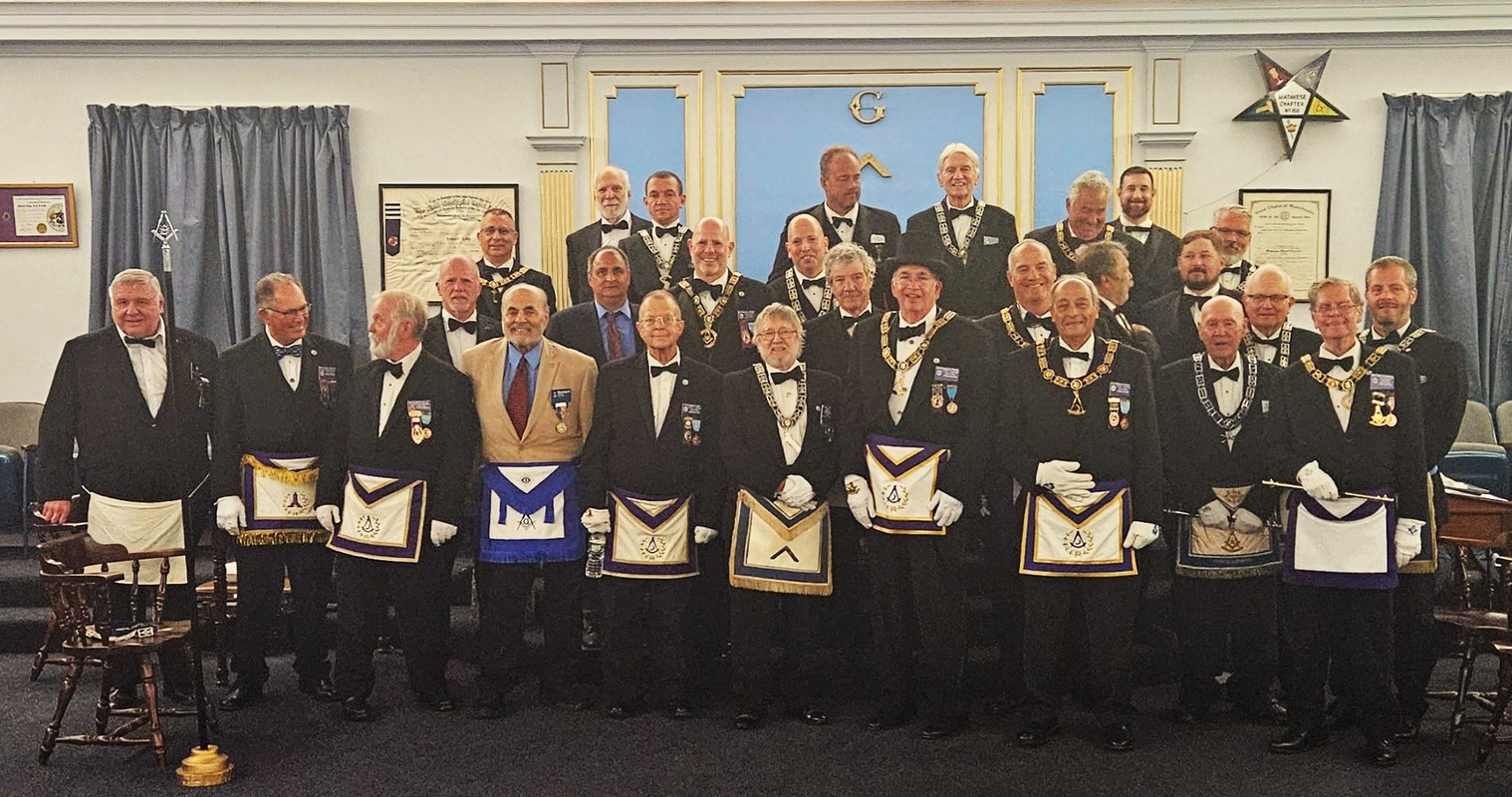 A gathering of masons at the installation of Howard Lodge with WM Barry Kromer standing next to the Grand Master of MA.